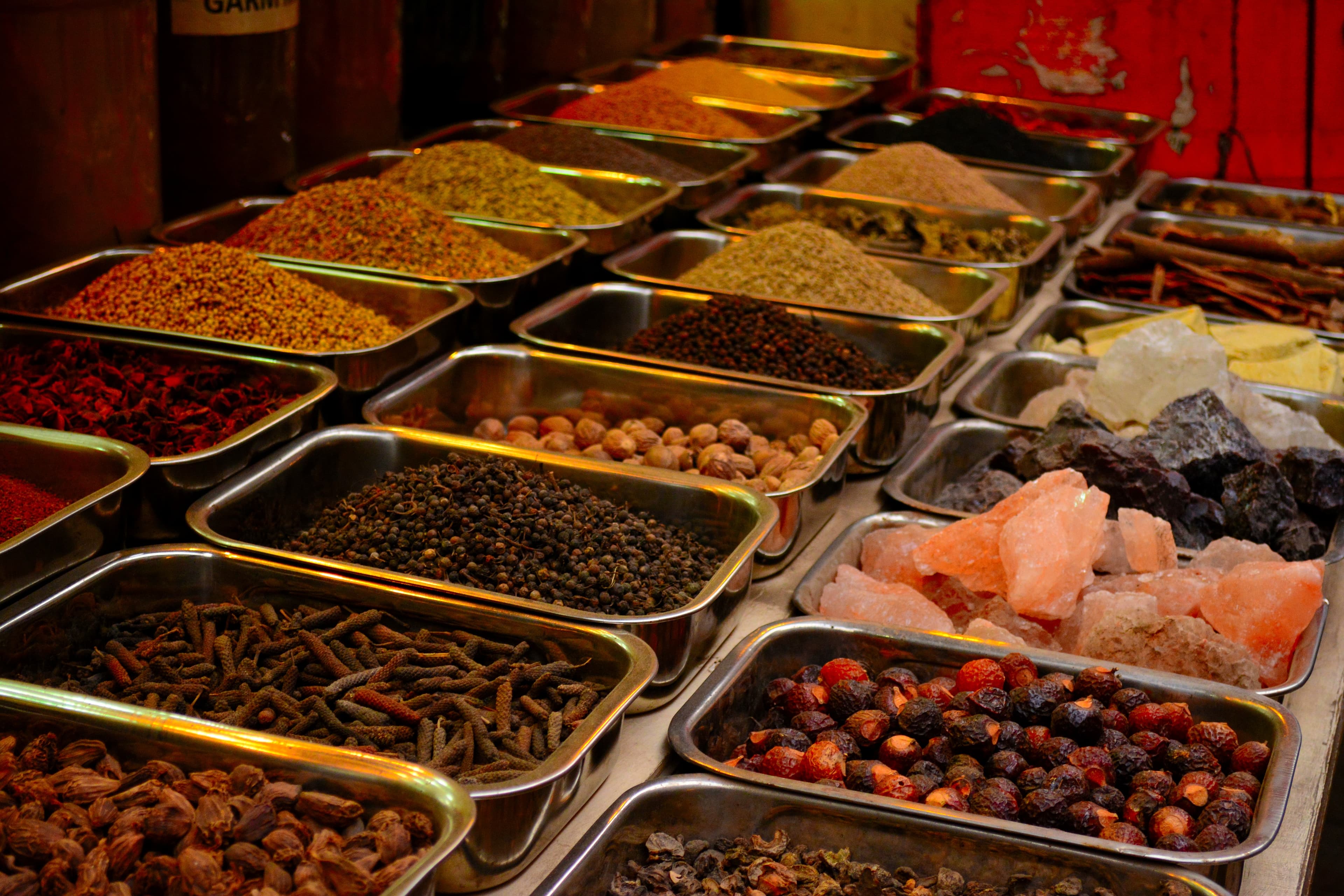 Whole biryani spices spread out — cardamom, clove, cinnamon, star anise